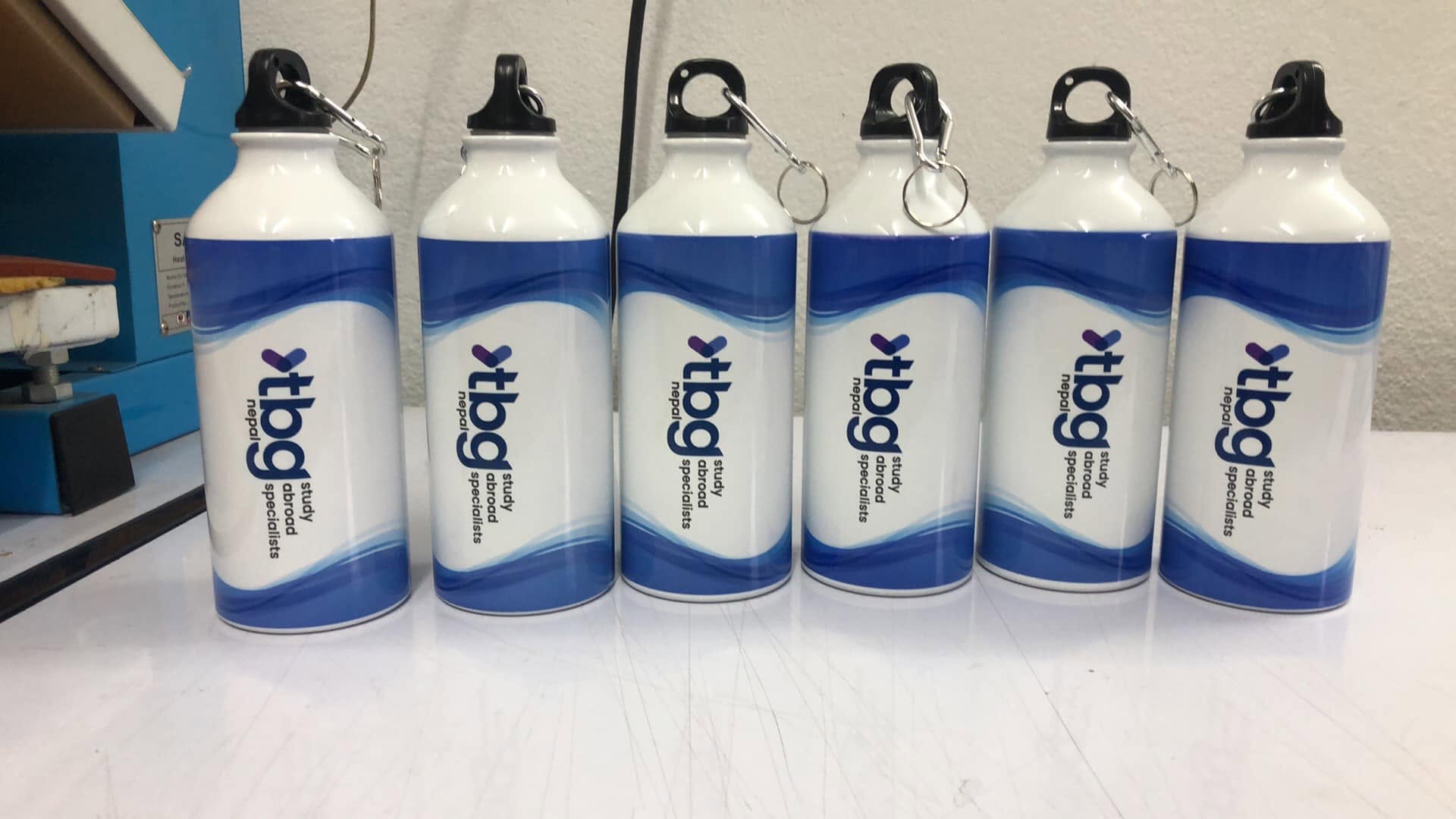 Branded white and blue sports bottles for a company